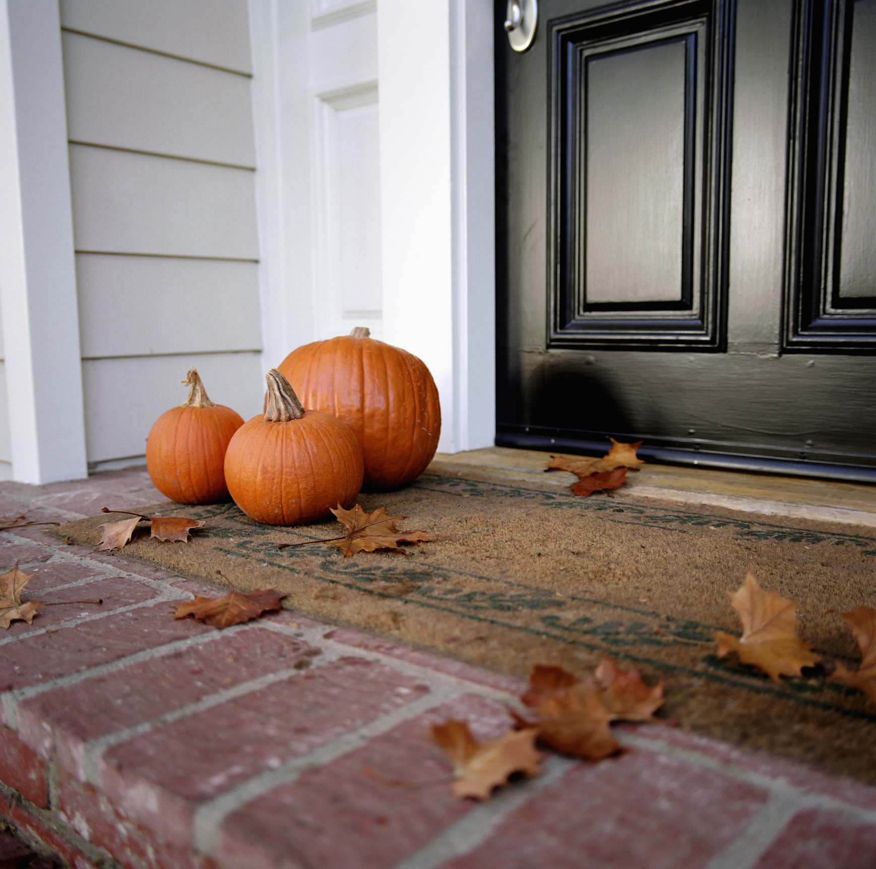Pumpkins In Front Of Door Of House